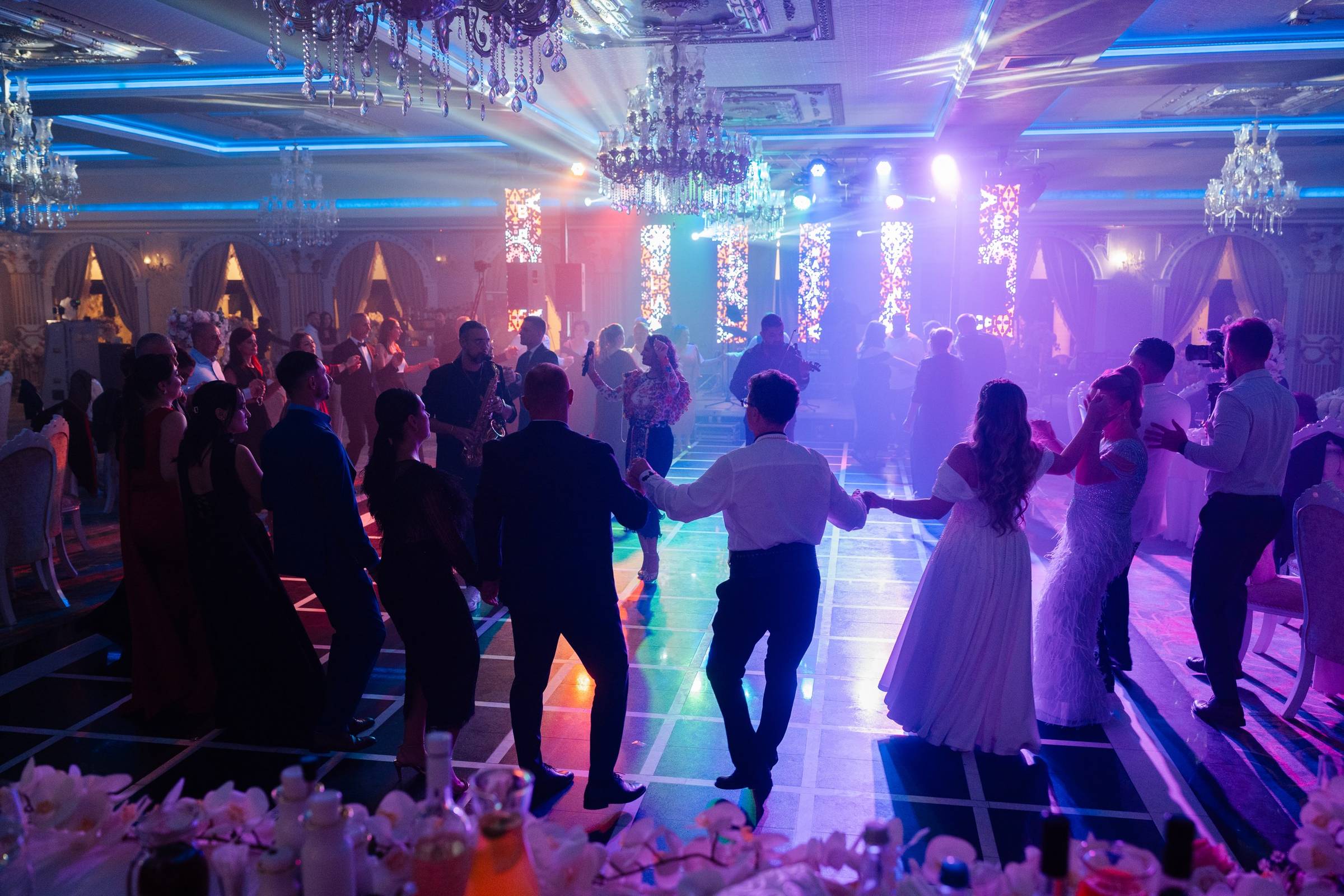 Invitații prinși în horă pe ringul sălii Imperial Events Deva, sub luminile de scenă